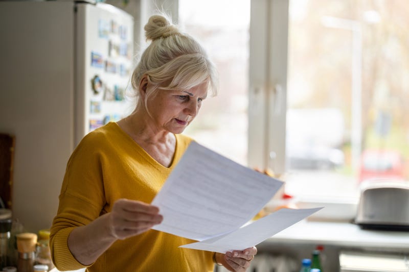 woman looking at forms in her hand