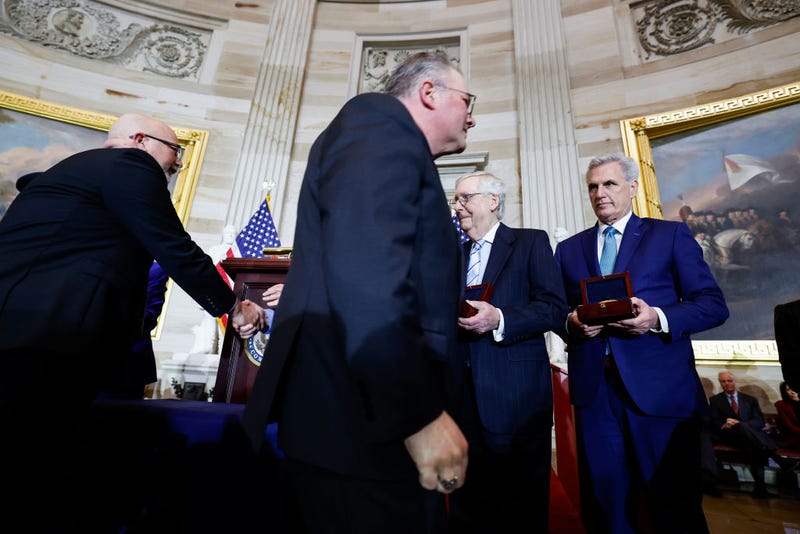 Kenneth and Craig Sicknick, the brothers of Capitol Police officer Brian Sicknick who died after the events of January 6, walk past Senate Minority Leader Mitch McConnell (R-KY) and House Minority Leader Kevin McCarthy (R-CA) during a Congressional Gold Medal Ceremony for U.S. Capitol Police and D.C.
