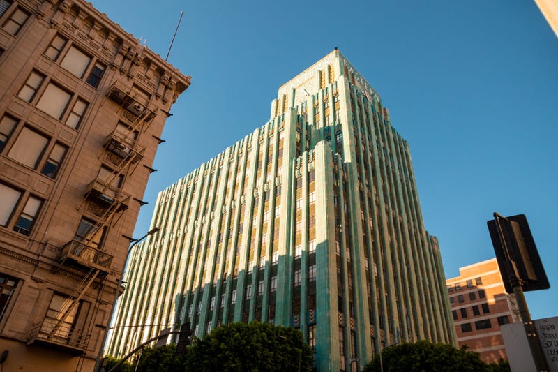 tall turquoise art deco building in downtown los angeles