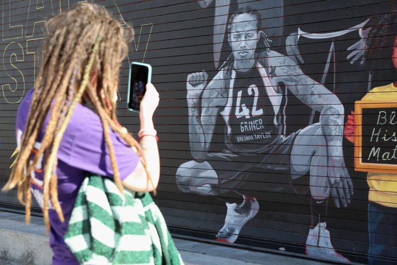 Phoenix Mercury fan Carley Givens takes a photo of a "Black Lives Matter" mural depicting Brittney Griner outside the Footprint Center on December 08, 2022 in Phoenix, Arizona. Christian Petersen/Getty Images