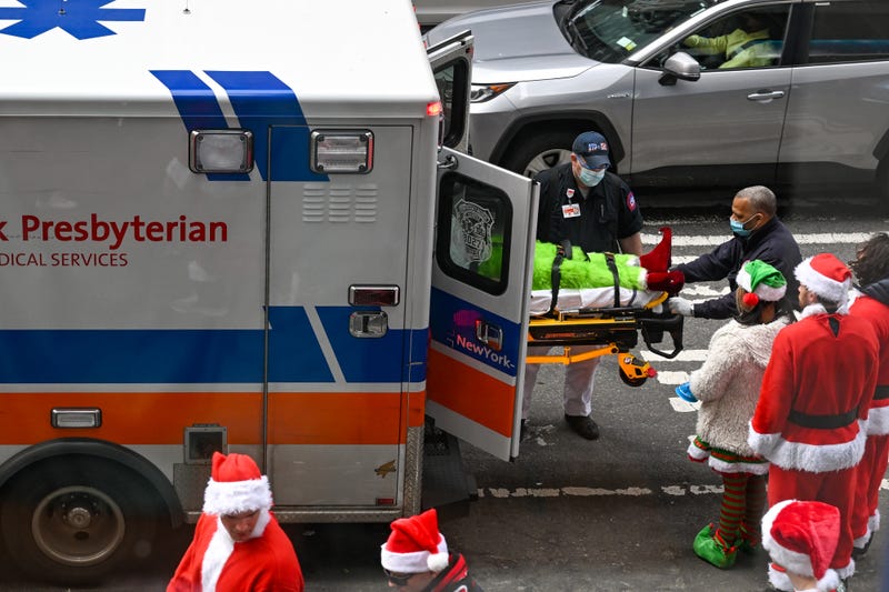 An intoxicated person is taken by paramedics during SantaCon