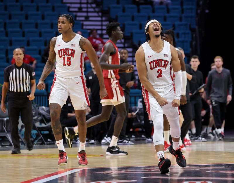 Luis Rodriguez #15 and Justin Webster #2 of the UNLV Rebels react after Webster hit a 3-pointer against the Washington State Cougars in the first half of their game during The Clash at MGM Grand Garden Arena