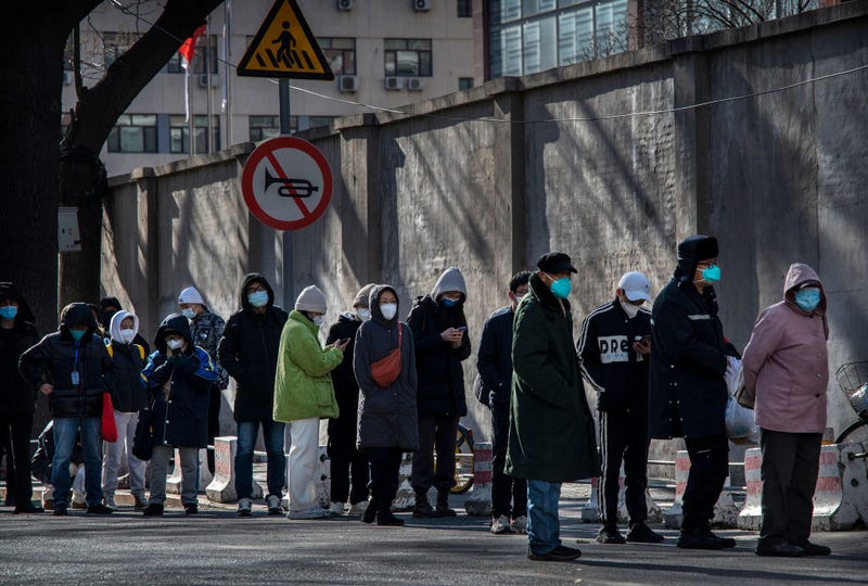 People line up outside a fever clinic at a hospital in the morning on December 11, 2022 in Beijing, China. 