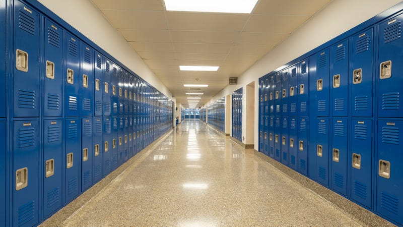 High school hallway with blue lockers along the walls