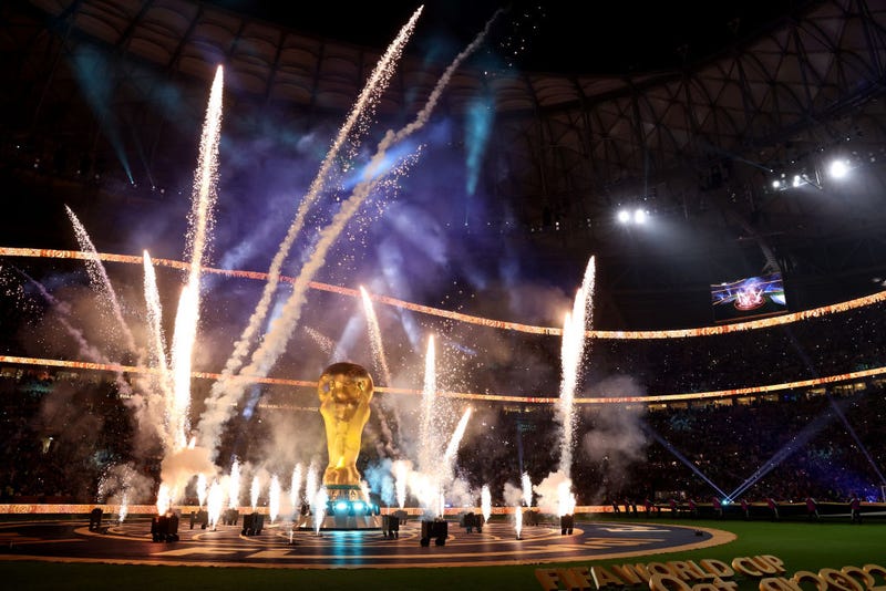 Pyrotechnics surround a giant FIFA World Cup trophy prior to the FIFA World Cup