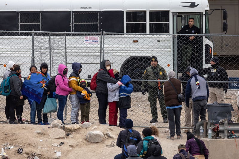 Immigrants seeking asylum turn themselves in to U.S. Border Patrol agents after wading across the Rio Grande to El Paso, Texas on December 18, 2022 from Ciudad Juarez, Mexico.