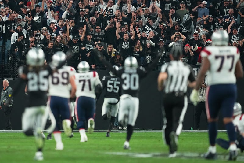 Fans cheer as Chandler Jones #55 of the Las Vegas Raiders scores a touchdown to defeat the New England Patriots at Allegiant Stadium on December 18, 2022