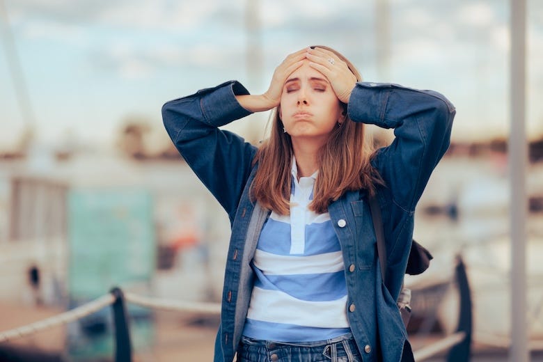 Stressed woman with her hands on her head