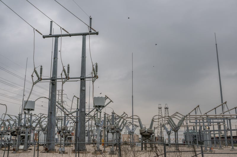 Transmission towers at a powerplant near the Energy Research Park facility on Dec. 22, 2022, in Houston, Texas.