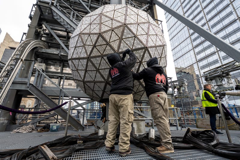 Workers install Waterford Crystal triangles atop One Times Square on Dec. 27, 2022