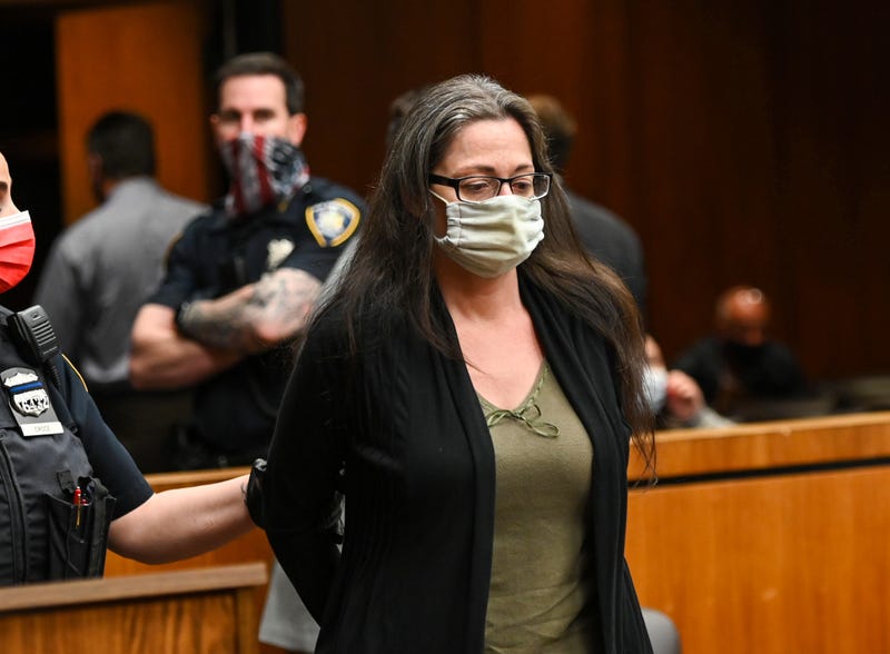 Angela Pollina who is charged with second-degree murder in the death of eight-year-old Thomas Valva, stands handcuffed inside Suffolk County Court in Riverhead, New York on May 13, 2021.