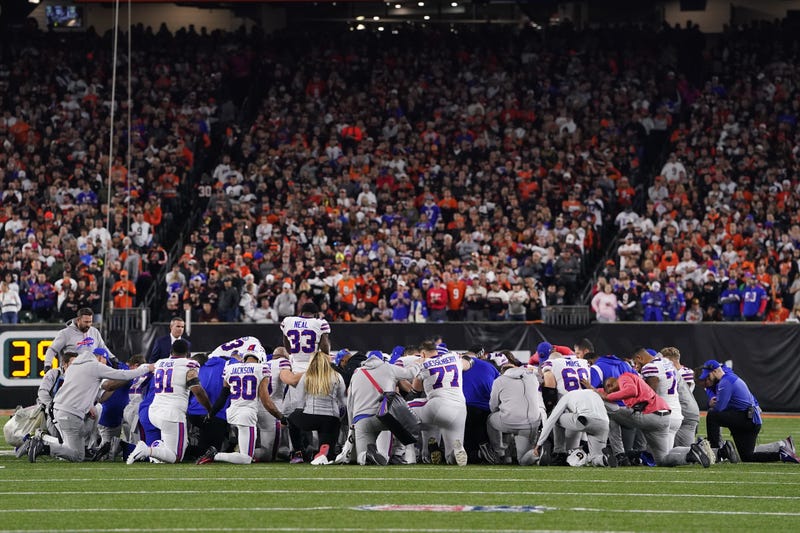 Buffalo Bills players huddle and pray after teammate Damar Hamlin, #3, collapsed on the field after making a tackle against the Cincinnati Bengals during the first quarter at Paycor Stadium on Jan. 2, 2023, in Cincinnati, Ohio. 