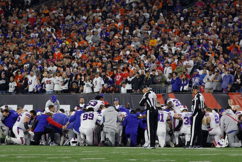 Buffalo Bills players huddle after teammate Damar Hamlin #3 collapsed following a tackle against the Cincinnati Bengals during the first quarter at Paycor Stadium on January 02, 2023 in Cincinnati, Ohio. 