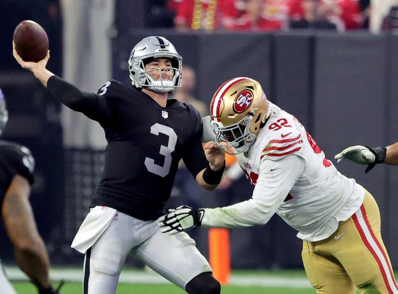 Quarterback Jarrett Stidham #3 of the Las Vegas Raiders is hit as he throws by defensive end Kerry Hyder Jr. #92 of the San Francisco 49ers in the fourth quarter of their game at Allegiant Stadium on January 01, 2023 in Las Vegas, Nevada.