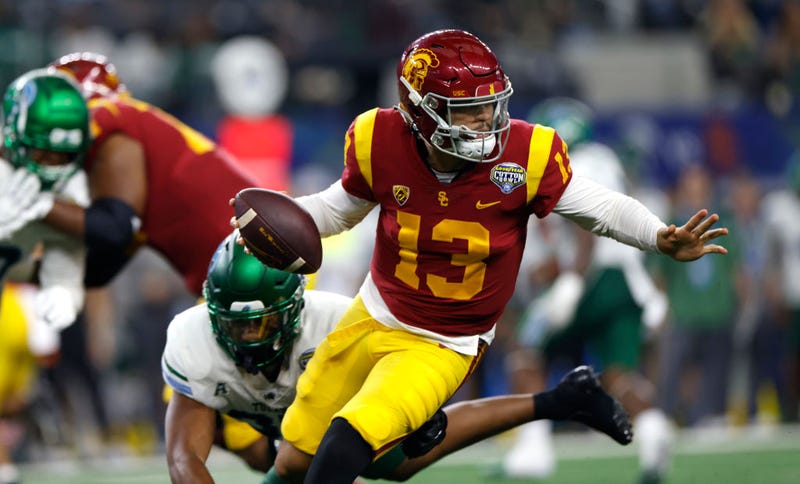 Caleb Williams #13 of the USC Trojans scrambles against the Tulane Green Wave in the first half of the Goodyear Cotton Bowl Classic on January 2, 2023 at AT&T Stadium in Arlington, Texas.