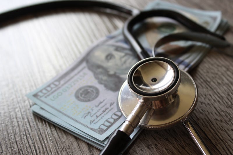 A stethoscope with some money.