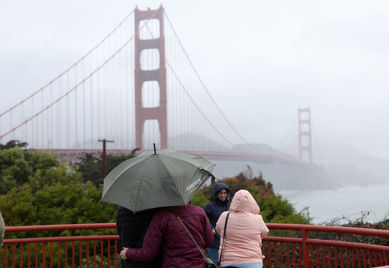 People visit the Golden Gate Bridge as a rain storm moves through the area on January 04, 2023 in San Francisco, California.