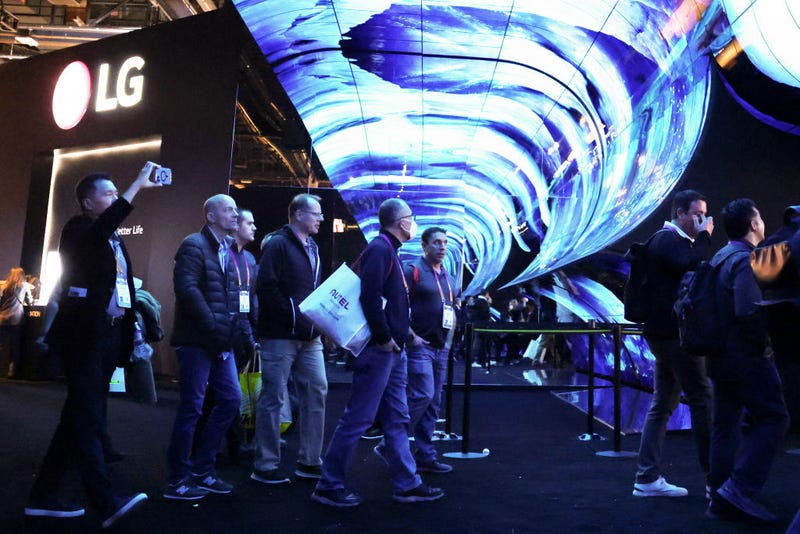 Attendees enter the LG booth under an AV display at CES 2023 at the Las Vegas Convention Center on Jan. 5, 2023 in Las Vegas, Nevada. CES, the world's largest annual consumer technology trade show, runs through Jan. 8.