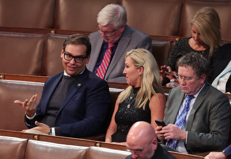 U.S. Rep.-elect George Santos (R-NY) (L) talks to Rep.-elect Marjorie Taylor Greene (R-GA) in the House Chamber during the third day of elections for Speaker of the House at the U.S. Capitol Building on January 05, 2023 in Washington, DC.