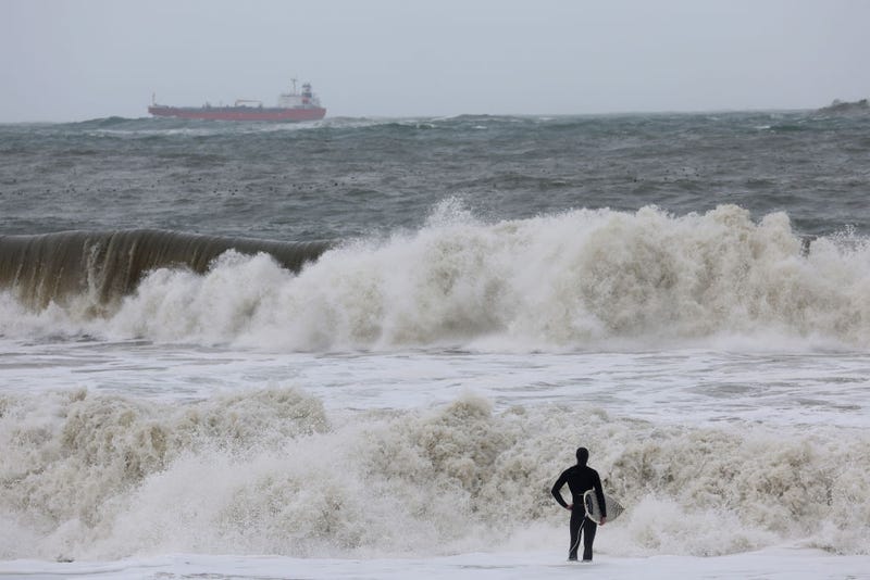 A surfer looks out at rough surf as a storm comes in Rodeo Beach on January 07, 2023 in Sausalito, California.