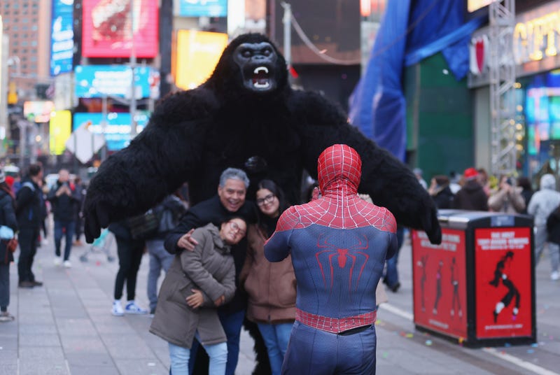 Tourists pose for photos in Times Square this year