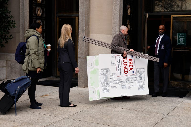 A map of the U.S. Capitol and an example of a sign used by police on Jan. 6, 2021, are carried into the U.S. District Court building on Jan. 12, 2023, in Washington, D.C. Opening arguments have begun in the trial of members of the Proud Boys accused of seditious conspiracy for their role in the attack on the U.S. Capitol.