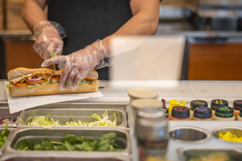 An employee halves a Subway sandwich at a Subway restaurant on January 12, 2023 in Austin, Texas. 
