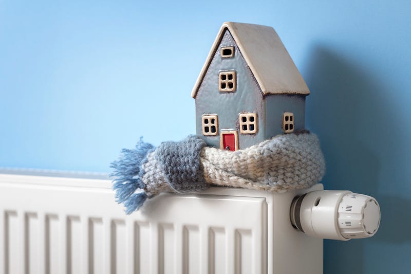 House model wrapped in scarf on a radiator.