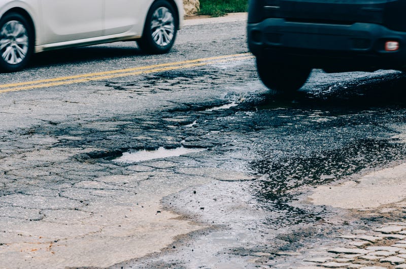 Large pothole in the middle of the road.