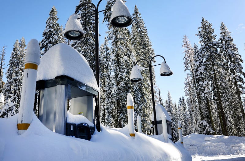 Gas pumps are partially buried in snow, at a service station closed for the winter, after a series of atmospheric river storms on January 20, 2023 in Yosemite National Park, California.