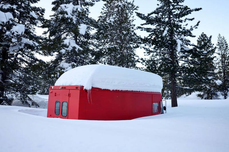 A vehicle is partially buried in snow after a series of atmospheric river storms on January 20, 2023 near South Lake Tahoe, California. 