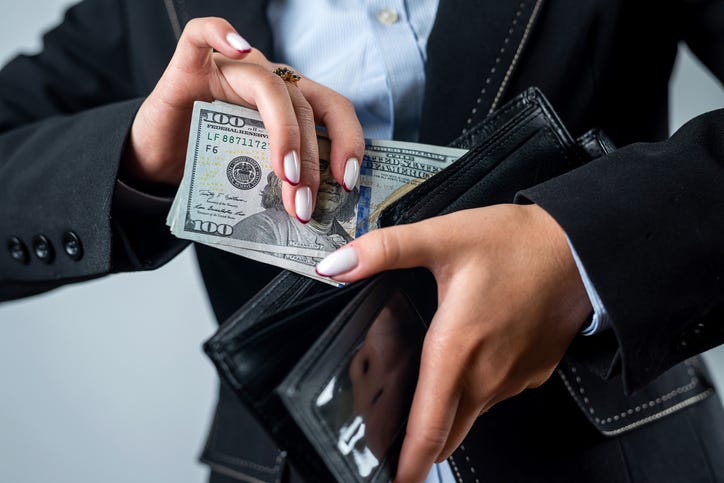 woman stealing money is portrayed in a stock image