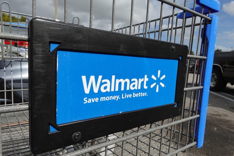A cart sits outside of a Walmart store on January 24, 2023 in Miami, Florida. Walmart announced that it is raising its minimum wage for store employees in early March, store employees will make between $14 and $19 an hour. 
