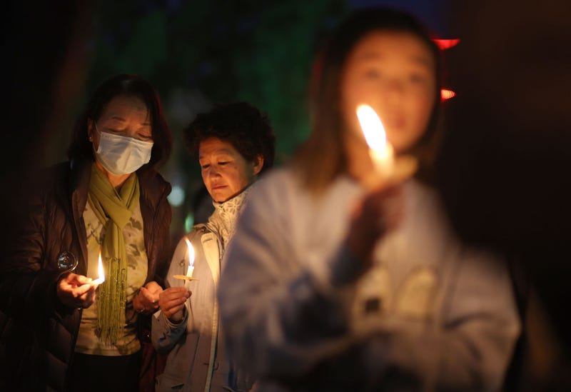 People hold candles during a candlelight vigil for the victims of the recent mass shootings in Monterey Park and Half Moon Bay on January 26, 2023 in San Francisco, California.