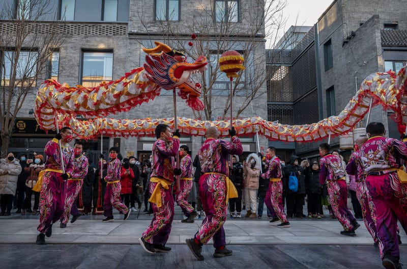Members of a dragon dance troupe perform at the opening of a clothing store in a shopping area during Chinese Lunar New Year and Spring Festival activities on January 27, 2023 in Beijing, China.