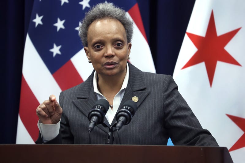 Lori Lightfoot at lectern, during news conference