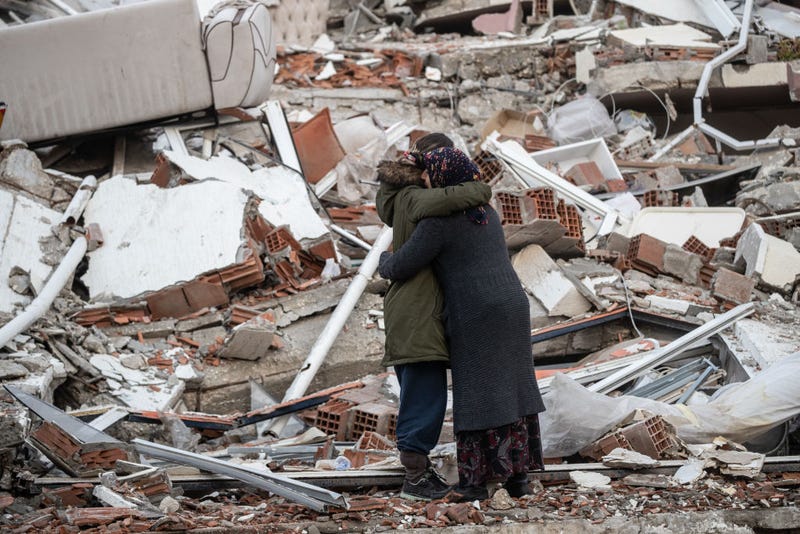 Women hug each other near the collapsed building on February 07, 2023 in Hatay, Turkey.