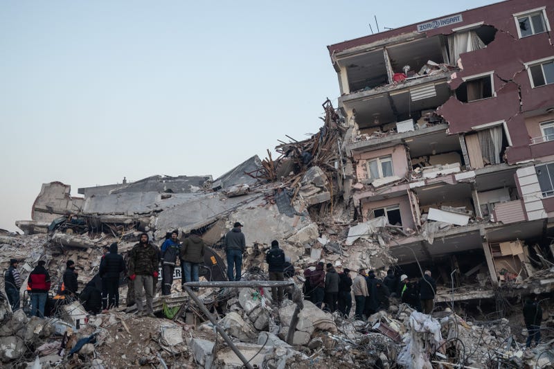 People wait for news of their loved ones, believed to be trapped under collapsed building on on February 09, 2023 in Hatay, Turkey. A 7.8-magnitude earthquake hit near Gaziantep, Turkey, in the early hours of Monday, followed by another 7.5-magnitude tremor just after midday. The quakes caused widespread destruction in southern Turkey and northern Syria and were felt in nearby countries.