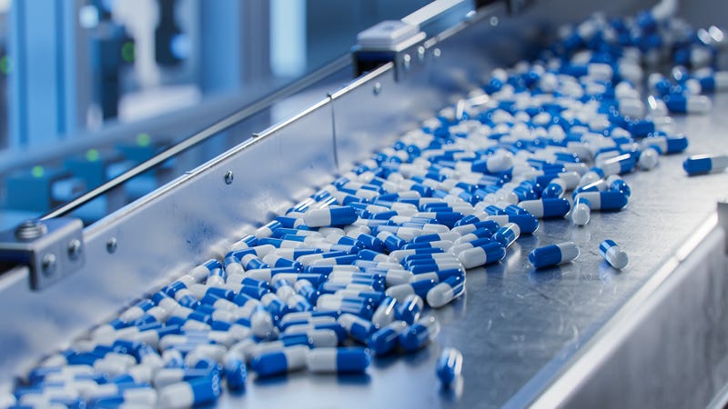 capsules on a conveyer belt