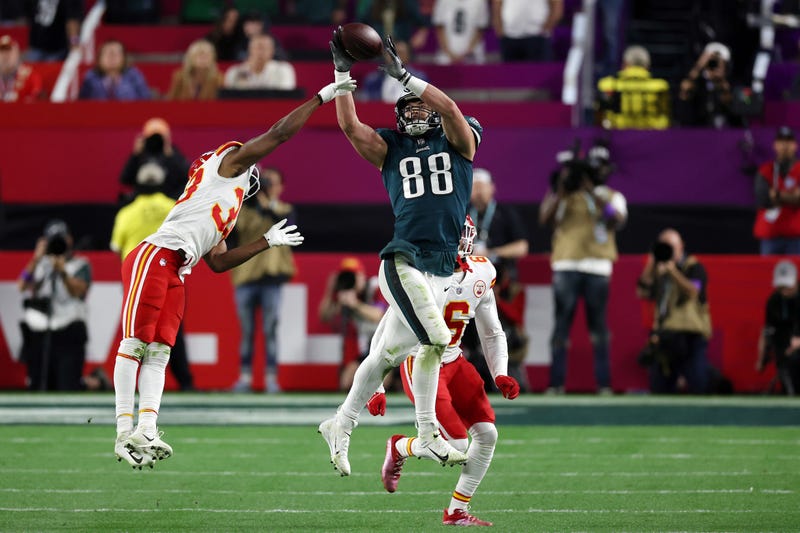Dallas Goedert of the Philadelphia Eagles reaches for a catch against L'Jarius Sneed of the Kansas City Chiefs and Bryan Cook of the Kansas City Chiefs during the third quarter in Super Bowl LVII at State Farm Stadium on February 12, 2023 in Glendale, Arizona.