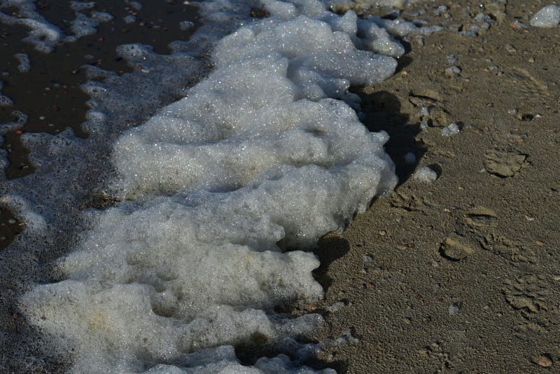 Foam piling up on beach