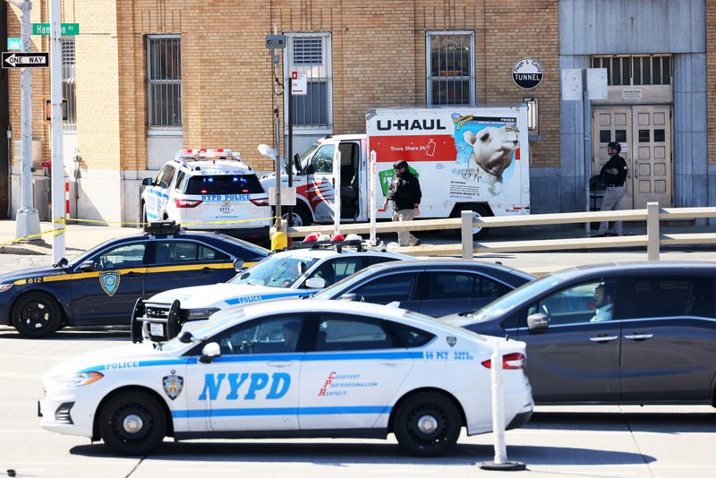 NYPD officers search a crashed U-Haul truck on Hamilton Avenue on Feb. 13, 2023, in Red Hook, Brooklyn