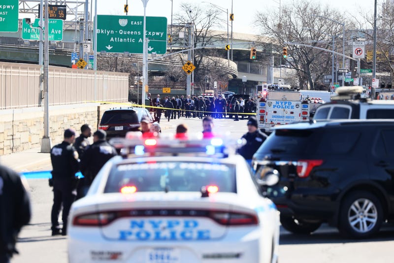 NYPD officers stand guard as a search of crashed U-Haul truck is conducted on Hamilton Avenue on Feb. 13, 2023, in Red Hook, Brooklyn