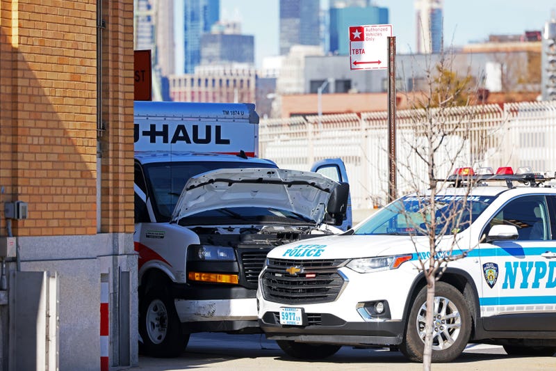 An NYPD vehicle is seen parked in front of a crashed U-Haul truck on Hamilton Avenue on Feb. 13, 2023, in Red Hook