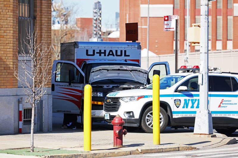 An NYPD vehicle is seen parked in front of a crashed U-Haul truck on Hamilton Avenue on February 13, 2023 in the Red Hook neighborhood of the Brooklyn borough in New York City.