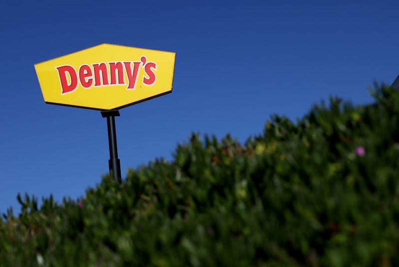 A sign is posted in front of a Denny's restaurant on February 13, 2023 in Emeryville, California.