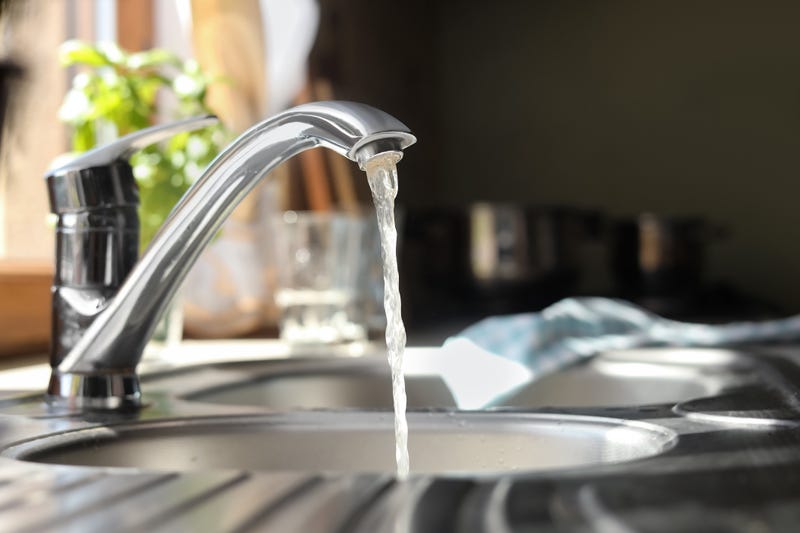 Water running from tap into kitchen sink.