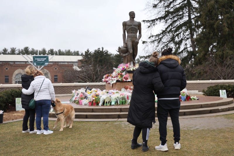 Mourners gather around the Sparty Statue after MSU shooting