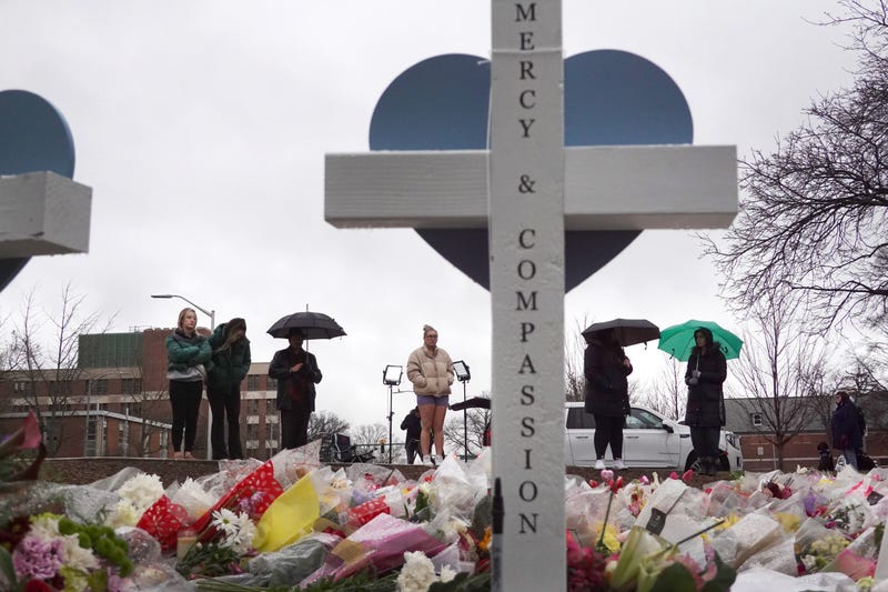 EAST LANSING, MICHIGAN - FEBRUARY 16: Flowers and crosses are set at the base of "The Rock" statue on the campus of Michigan State University as a tribute to the students killed and wounded in Monday's shooting on February 16, 2023 in East Lansing, Michigan. On February 13, a gunman opened fire on the campus, killing three students and critically wounding five others. The gunman shot himself a short time later during a confrontation with law enforcement officials. (Photo by Scott Olson/Getty Images)
