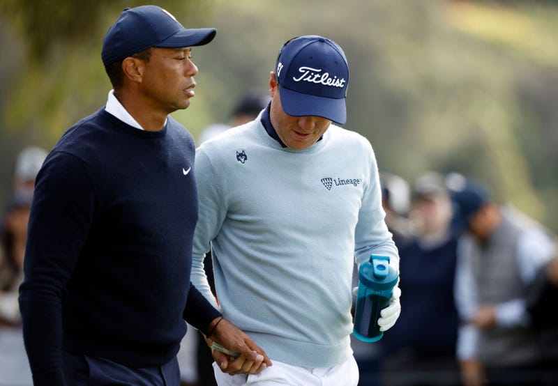 Tiger Woods of the United States (L) and Justin Thomas of the United States walk off the ninth tee during the first round of the The Genesis Invitational at Riviera Country Club on February 16, 2023 in Pacific Palisades, California. 